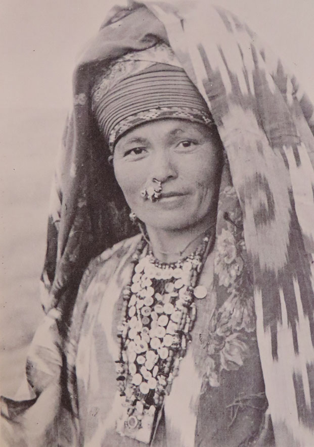 A Turkmen woman wearing traditional costume and tribal beaded choker necklace